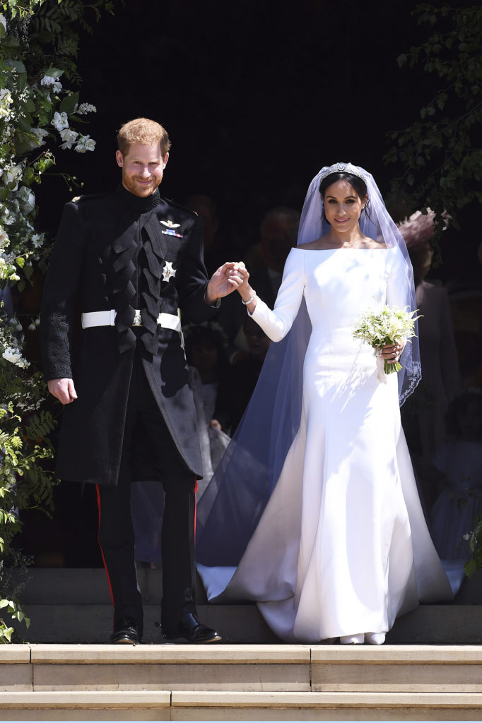Prince Harry and Meghan Markle exit St George's Chapel in Windsor Castle, Markle wearing her famously simple Givenchy wedding dress.