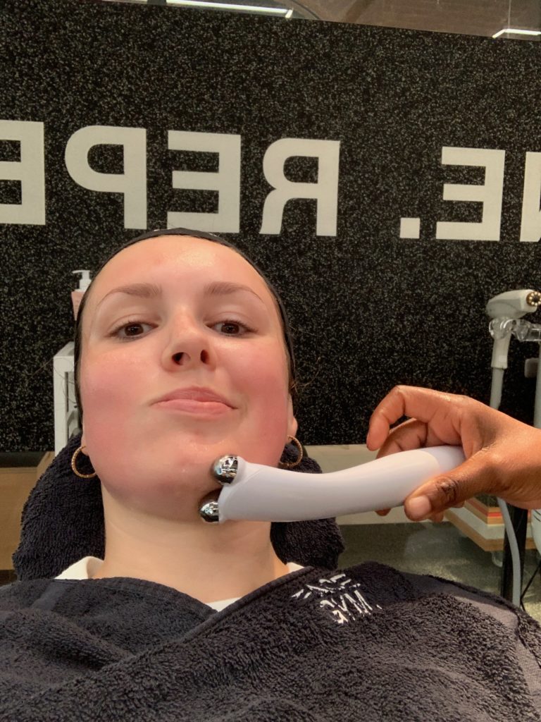 My aesthetician using the Pure Lift face microcurrent device, stimulating my facial muscles and causing them to involuntarily move.