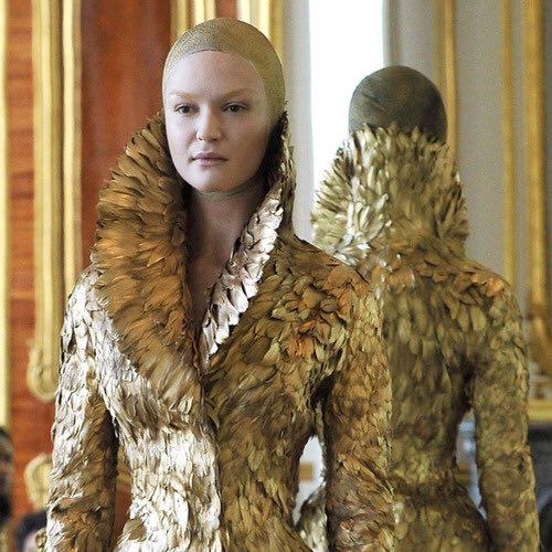 The iconic gold feather coat in the designer&squot;s final collection, "Angels and Demons," Fall/Winter 2010.