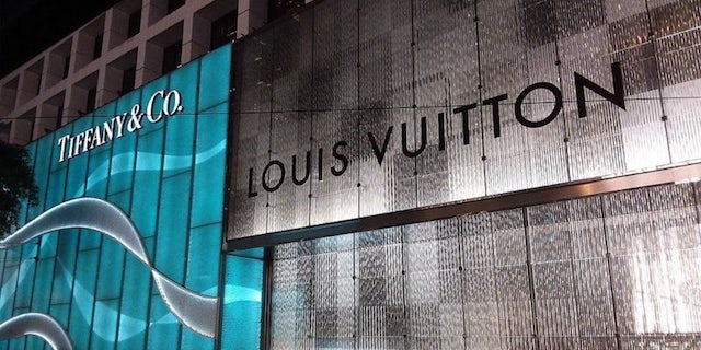 A Louis Vuitton and Tiffany & Co. store side by side.
