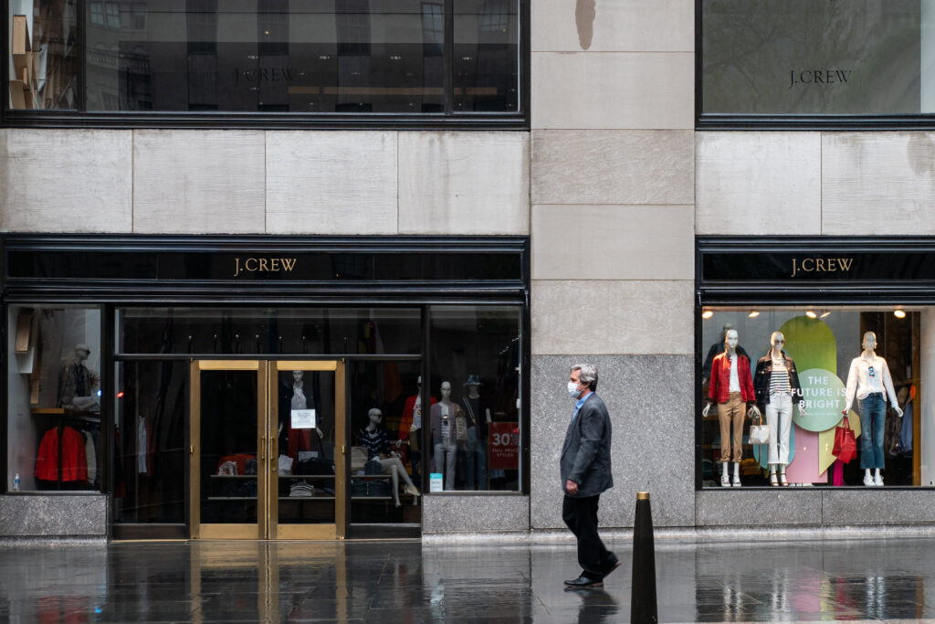 A man walks by a closed J. Crew in New York City.