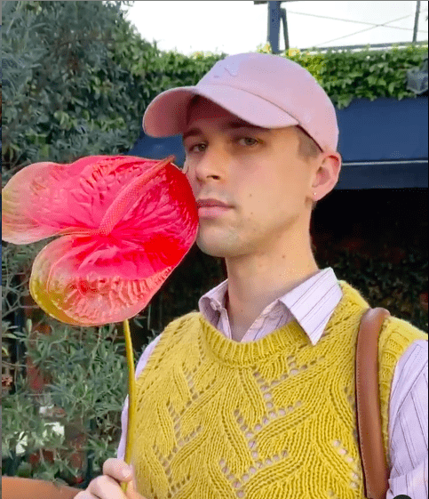 13 Reasons Why's Tommy Dorfman adds structure to his sweater vest look with a button down underneath.