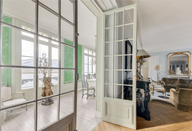 Natural light flows throughout the home, aided by original French doors and an enclosed porch.
